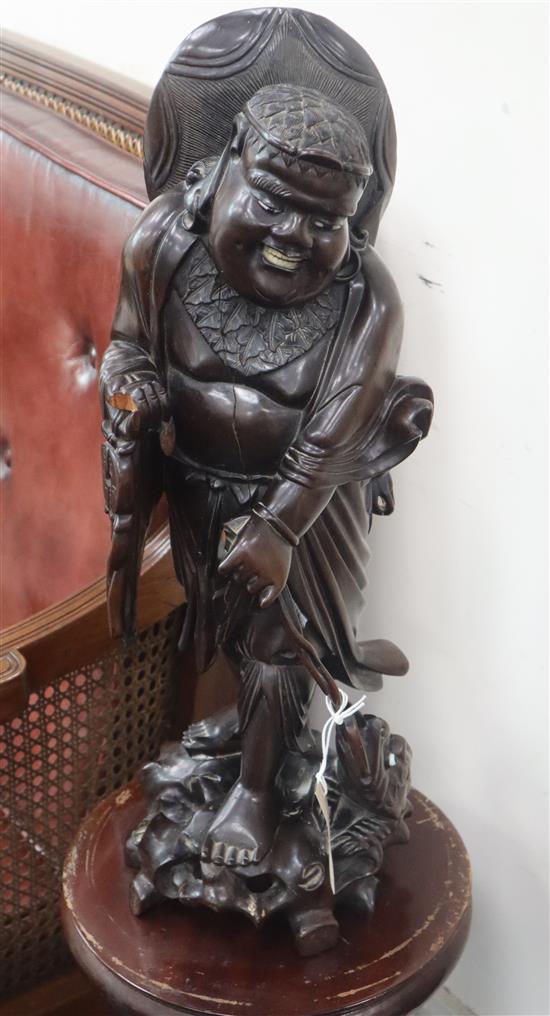 An Eastern carved hardwood figure of a deity height 54cm